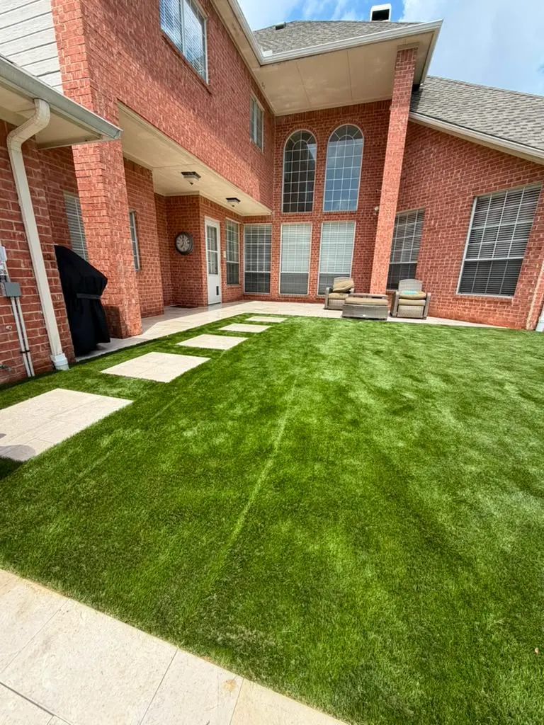 Artificial turf courtyard with large concrete stepping stones