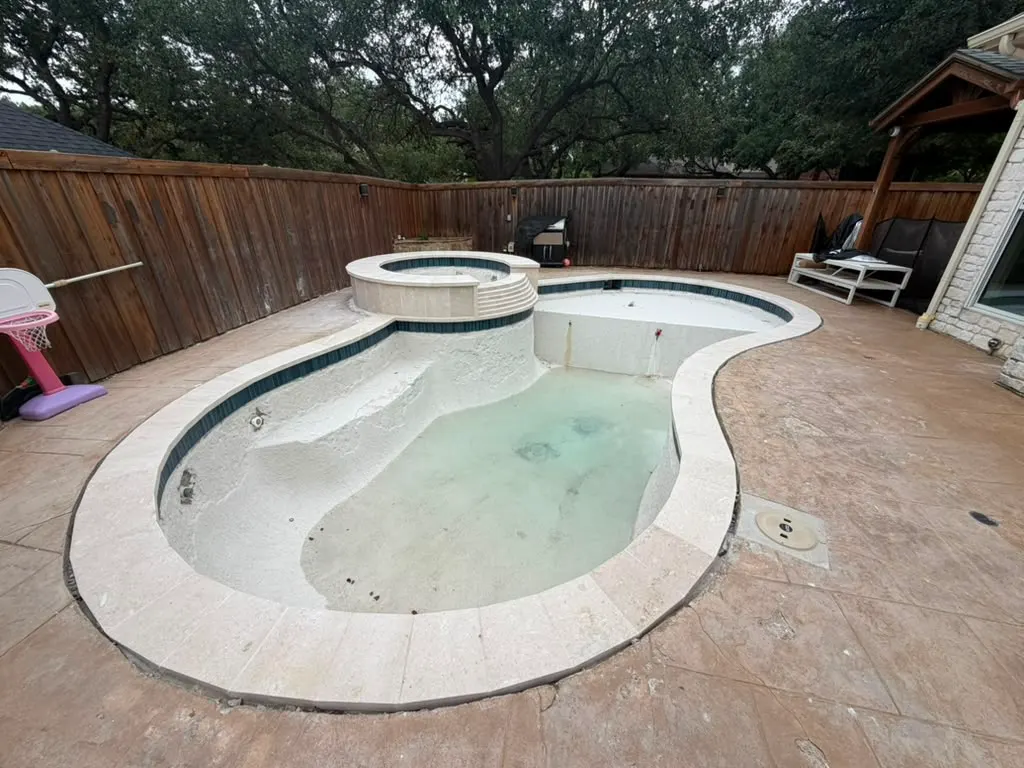 Swimming pool and raised spa prepared during a remodeling project