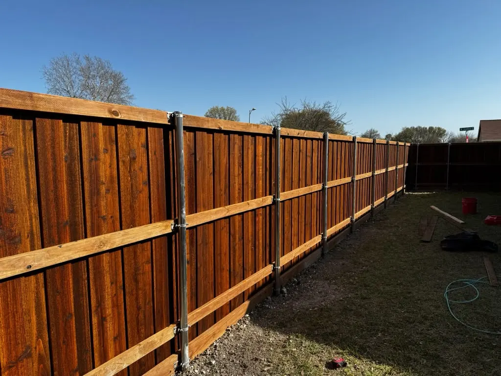 Interior structure and metal posts of a cedar privacy fence
