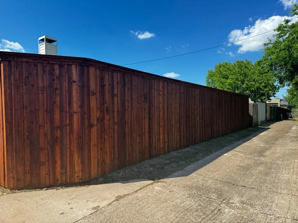 Long cedar privacy fence installed beside an alley